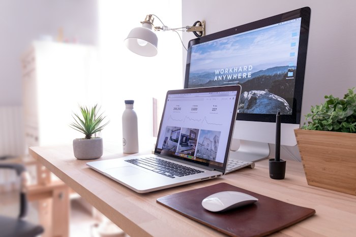 Laptop and desktop screens side by side